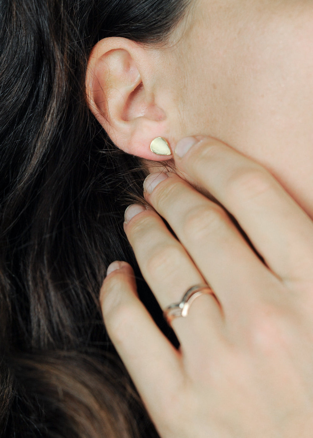 Handgemaakte oorstekers van 14 karaat geelgoud, ontworpen en gemaakt door Lianne de Witte in haar atelier in Goes, op model.