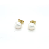 Handgemaakte oorsieraden van 14 karaat geelgoud met zoetwater parel wit, ontworpen en gemaakt door Lianne de Witte in haar atelier in Goes